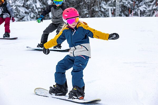 Child learns to snowboard in Kleinwalsertal Oberstdorf 